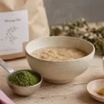 Poudre de moringa en cuillère, porridge et yaourt